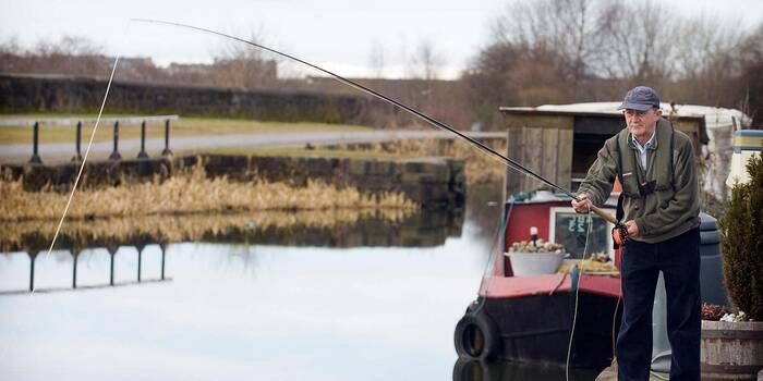 Fisherman floating on a Scottish Loch using a float tube. SCO 9129 Stock  Photo - Alamy